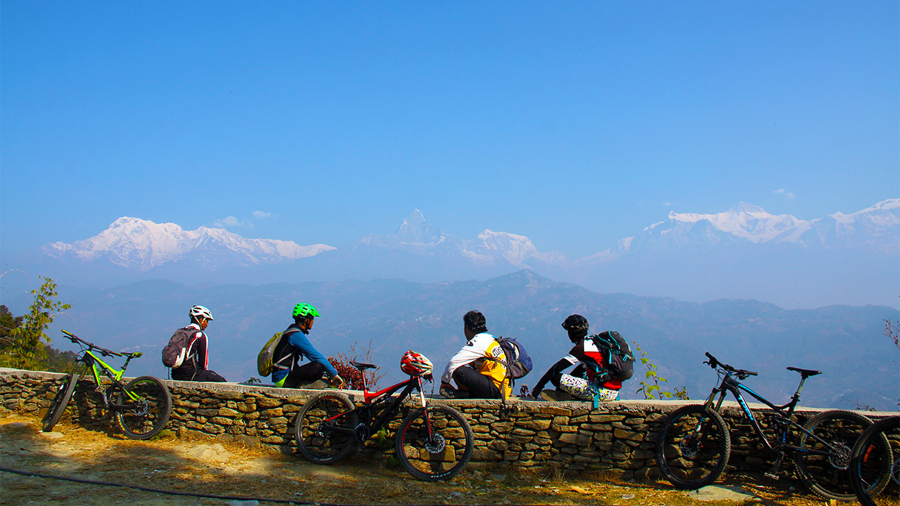 Mountain bikers are taking rest whilst observing Annapurna and Fishtail mountain.